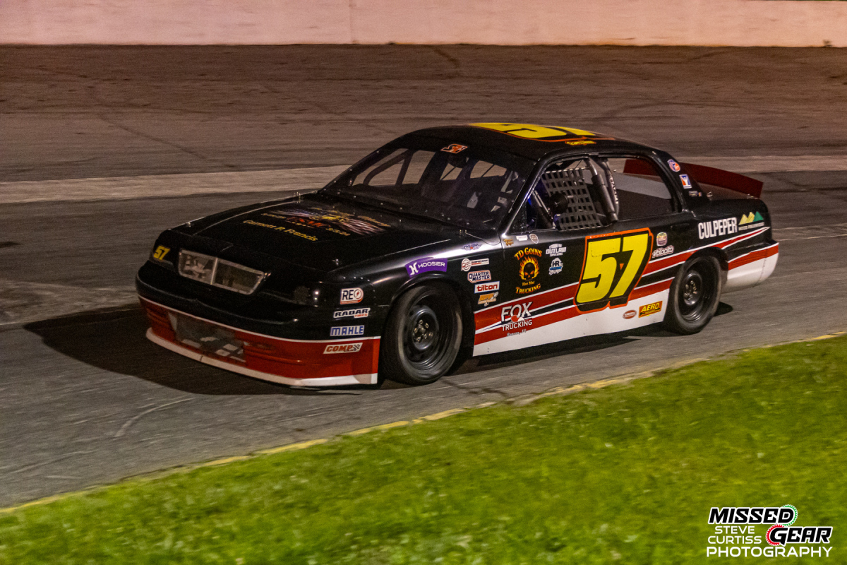 Crown Vic race cars competing on track